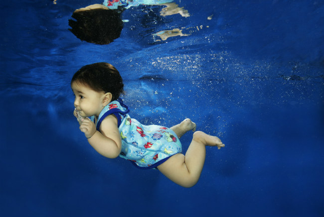 Child swimming wearing a Baby Wrap swimming costume from SplashAbout - Image copyright SplashAbout